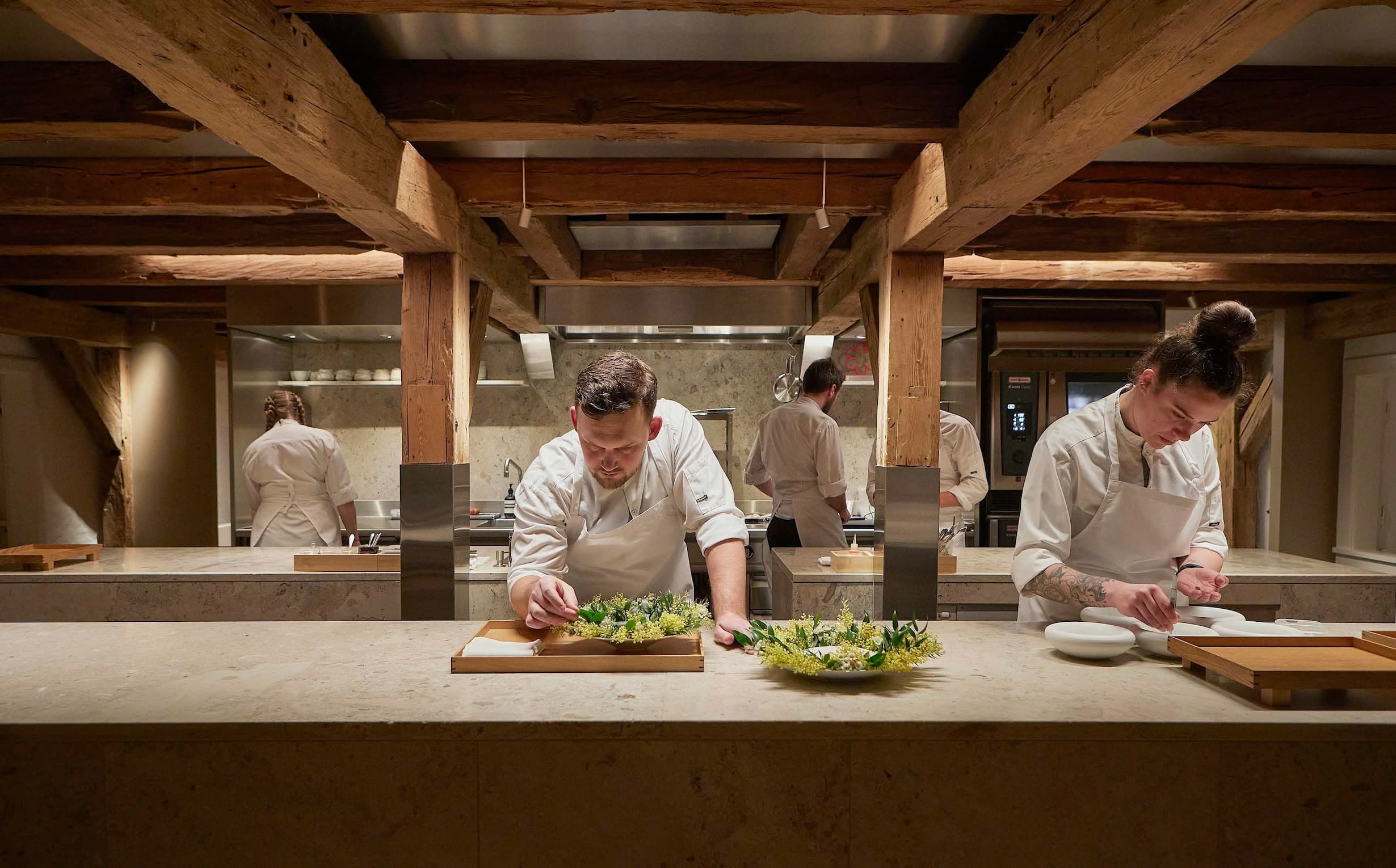 The team preparing seasonal ingredients in Aure’s open kitchen