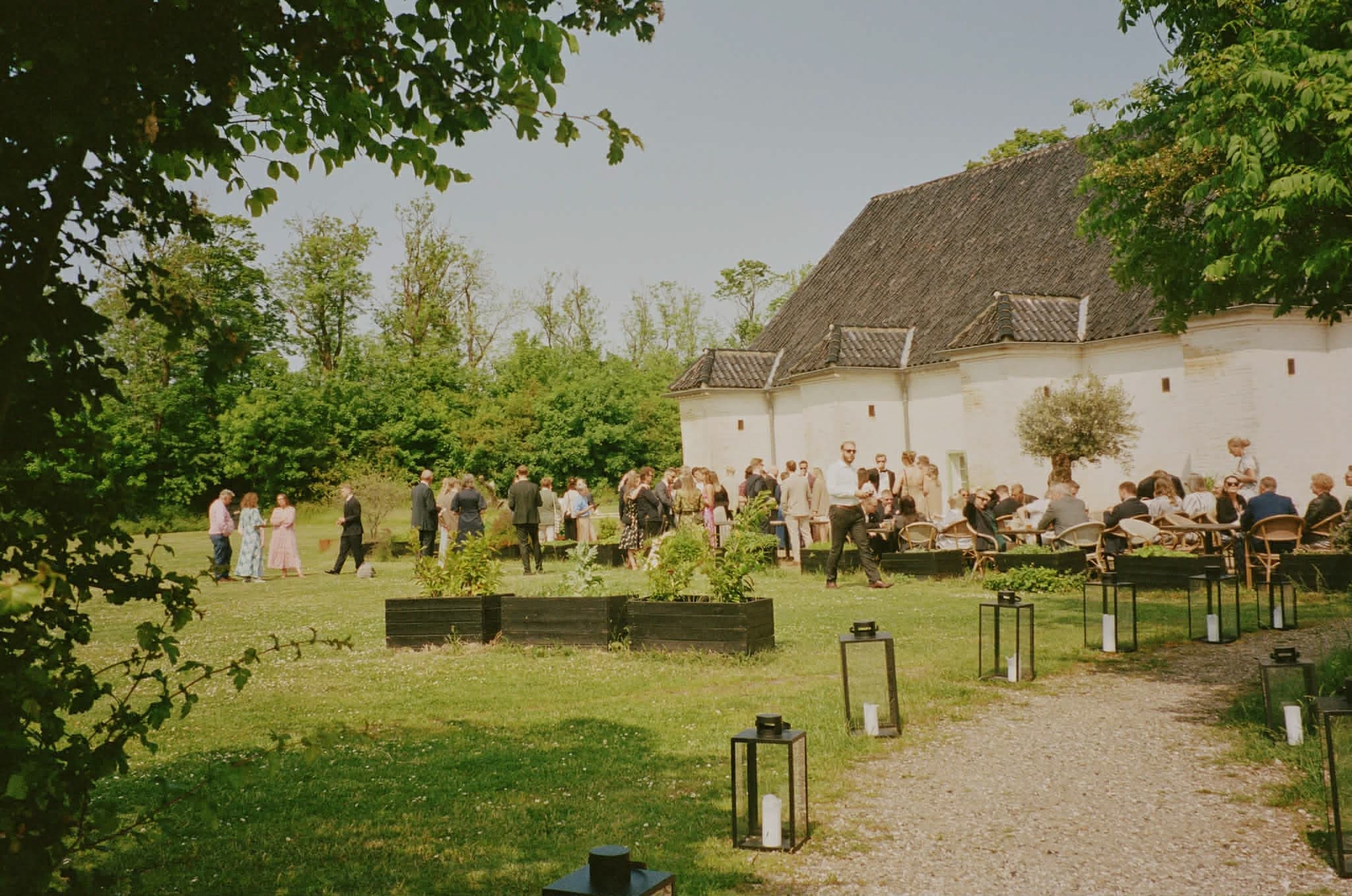 Guests celebrating in the garden outside Aure’s gunpowder house